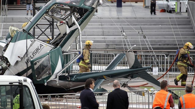 Firemen at scene of helicopter accident in Auckland, New Zealand Wednesday 