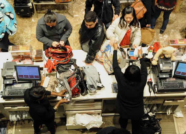 People make purchases inside Macy's department store in New York City 