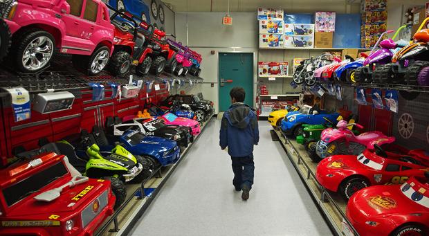 A young boy walks through aisles at the Toys-R-Us store 