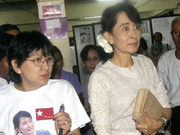 Myanmar democracy icon Aung San Suu Kyi, right, leaves her National League for Democracy (NLD) headquarters 