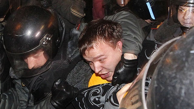 Police detain a demonstrator during protests against alleged vote rigging in Russia's parliamentary elections in Triumphal Square in Moscow, Russia, Dec. 6, 2011.  