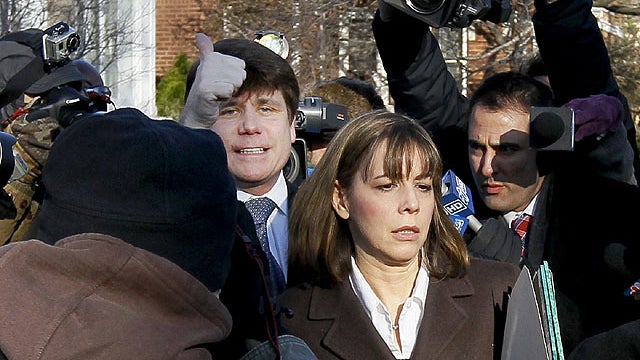 Former Illinois Gov. Rod Blagojevich, left, gives the thumbs-up as he leaves his home with his wife Patti in Chicago, Dec. 7, 2011, for the second day of his sentencing hearing on 18 corruption counts, including trying to auction off President Barack Obam 