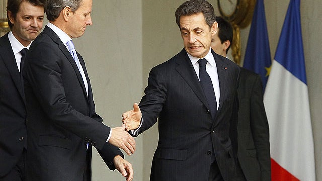 French President Nicolas Sarkozy, right, accompanies U.S. Treasury Secretary Timothy Geithner , center, as Finance Minister Francois Baroin, left, looks on after their meeting at the Elysee Palace in Paris, Dec. 7, 2011.  