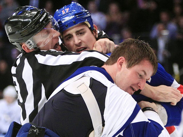 Dan O'Halloran separates Brandon Dubinsky and Marc-Andre Bergeron  