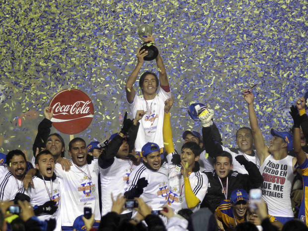 Lucas Lobos holds up the Mexican League soccer championship  