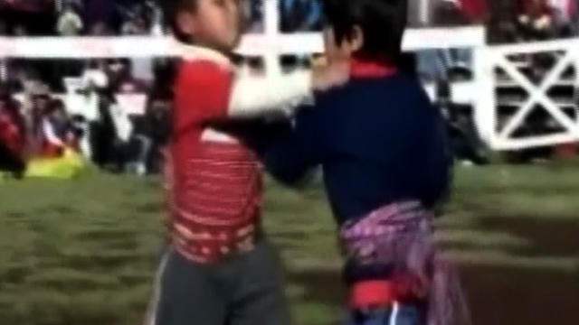 Two Peruvian children trade jabs during the annual "fighting festival" called Takanakuy in Chumbivilcas, Peru, Dec. 11, 2011. 