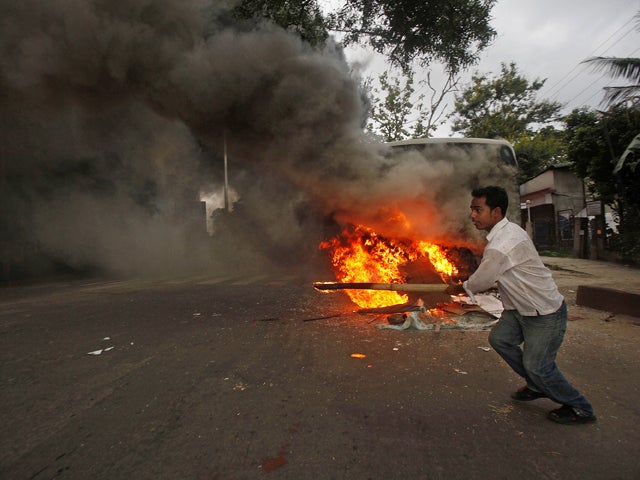 A protestor runs away after setting fire 