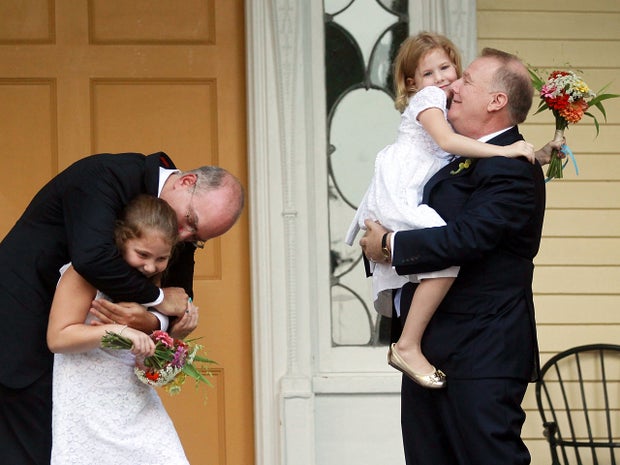 John Feinblatt, right and Jonathan Mintz, left celebrate after marrying with their daughters Maeve and Georgia 