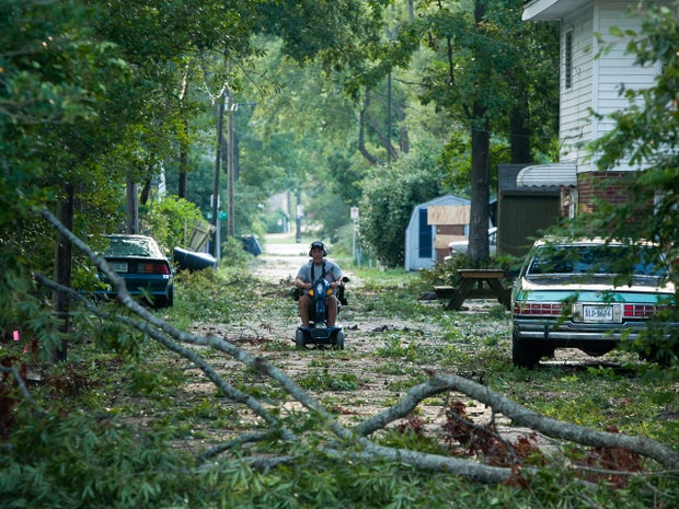 Branches litter an alley as a result of Hurricane Irene 