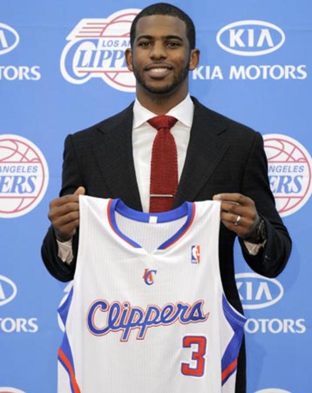 Chris Paul holds up his jersey 