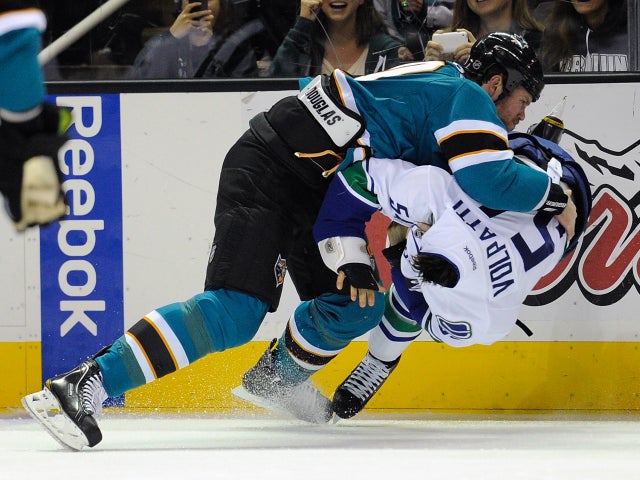 Brad Winchester takes Aaron Volpatti to the ice during a fight  