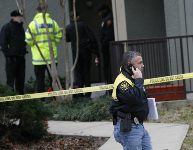 Grapevine police investigate the scene where they found seven people dead outside Dallas in Grapevine, Texas, Sunday, Dec. 25, 2011. Four women and three men who police believe to be related were found apparently shot to death, and authorities said they believe the shooter is among the dead. 
