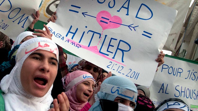 Anti-Syrian regime protesters shout slogans during a demonstration in Homs province, Syria, Dec. 21, 2011. 