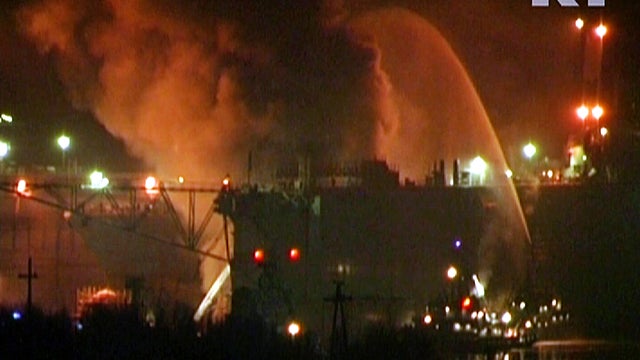 A grab from images released by Russia Today shows fire crews trying to extinguish a fire on board the Russian nuclear submarine Yekaterinburg docked in Murmansk, Russia, Dec. 29, 2011. Russian officials said the fire had been contained Dec. 30, 2011, and  