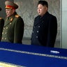 New North Korean leader Kim Jong Un, not in uniform, presides over a national memorial service for his late father, Kim Jong Il, at Kim Il Sung Square in Pyongyang, North Korea, Dec. 29, 2011. Ri Yong Ho, a vice marshal of the Korean People's Army, stands 
