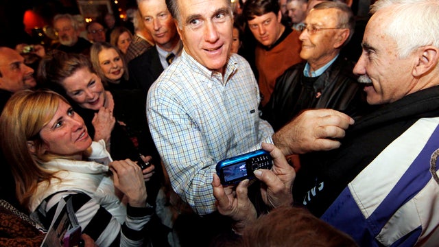 Former Massachusetts Gov. Mitt Romney makes his way through a crowd during a campaign stop at Old Salt Restaurant in Hampton, N.H., Dec. 31, 2011. 