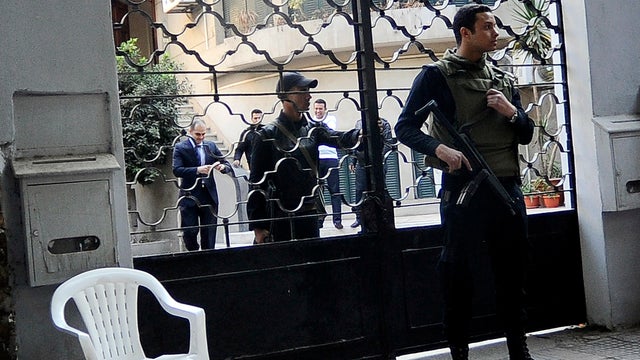 Egyptian soldiers stand guard in front of the U.S. National Democratic Institute, a non-governmental rights group in downtown Cairo Dec. 29, 2011. Egyptian police were searching the Cairo offices of American and Egyptian rights groups following orders by  
