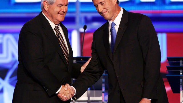 Republican presidential candidates Newt Gingrich, left, and Rick Santorum shake hands before the start of a presidential debate sponsored by CNN and The Tea Party Express at the Florida state fairgrounds Sept. 12, 2011, in Tampa, Fla. 