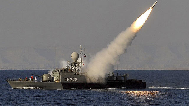 In this image made available by the Iranian Students News Agency, an Iranian navy vessel launches a missile during a drill at the sea of Oman, on Sunday, Jan. 1, 2012.  