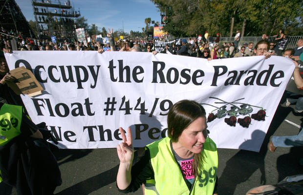 Occupy protesters march along Colorado Boulevard during the 123rd Tournament of   Roses Parade in Pasadena, Calif., Monday, Jan. 2, 2012. Several hundred Occupy   protesters marched at the end of the Rose Parade in a prearranged   demonstration. 