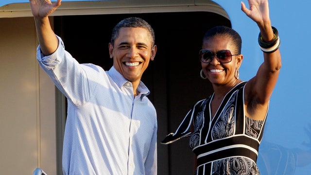 President Obama and first lady Michelle Obama wave before departing from Hickam Air Force Base in Honolulu Jan. 2, 2012. The first family was leaving Hawaii and returning to Washington from their holiday vacation. 