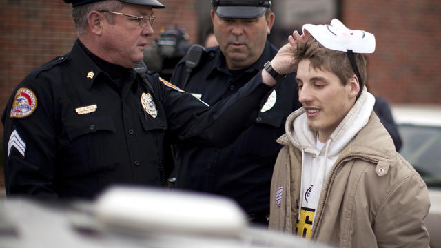 Police arrest an Occupy protester during a demonstration outside the headquarters of Republican presidential candidate Rep. Michele Bachmann, of Minnesota, Dec. 31, 2011, in Urbandale, Iowa. 