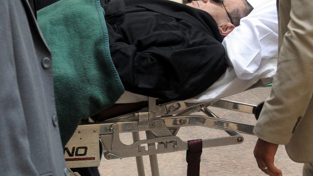 Ousted Egyptian President Hosni Mubarak is wheeled on a stretcher into court for his murder trial in Cairo Jan. 5, 2012. 