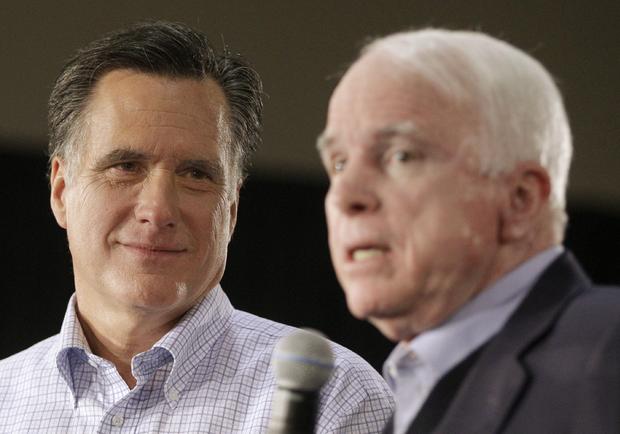 Mitt Romney listens at left, as Sen. John McCain speaks 