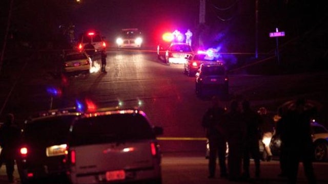 Police officers and emergency crew are seen near 3268 Jackson Street in Ogden, Utah 