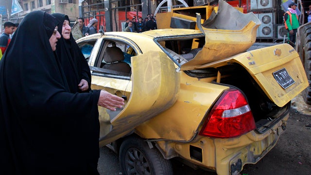 People inspect the scene of a bomb attack in Kazimiyah in the north of Baghdad Jan. 5, 2012. A wave of explosions struck two Shiite neighborhoods, killing and injuring dozens of Iraqis, police said, and intensifying fears that insurgents are stepping up a 