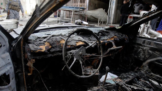 A policeman inspects the scene of a bomb attack in Kazimiyah in the north of Baghdad Jan. 6, 2012. 