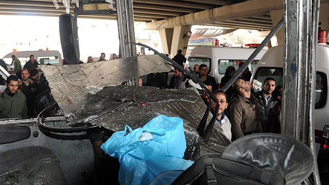 People gather at the site of a powerful explosion that hit the Midan neighbourhood in the heart of Damascus on January 6, 2012 as state media said a suicide bomb attack ripped through the Syrian capital, killing or wounding "dozens."  