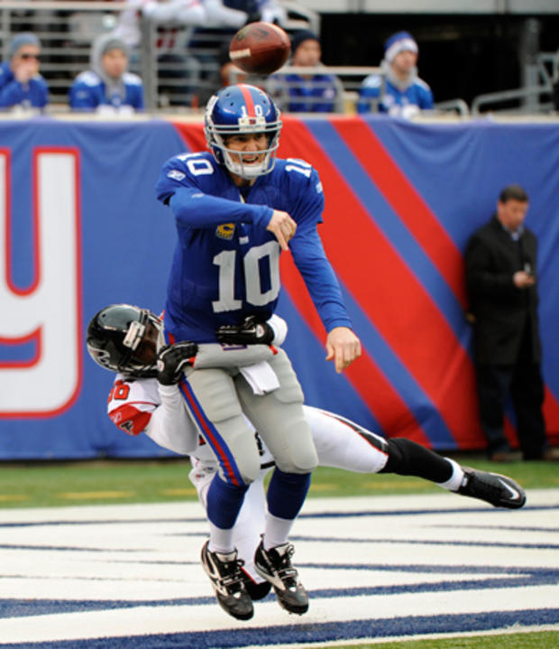 Eli Manning is tackled in the end zone 