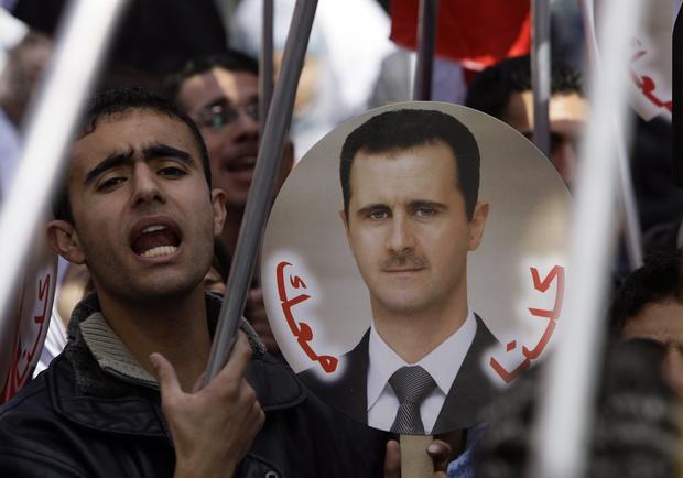 Syrian supporters of President Bashar Assad at a rally 