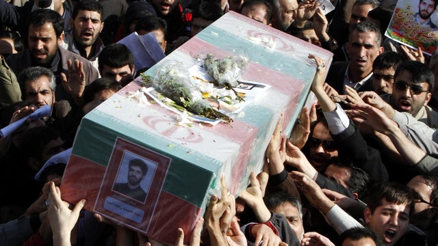 Iranians carry Jan. 13, 2012, the flag-draped coffin of Mostafa Ahmadi Roshan, a chemistry expert and a director of the Natanz uranium enrichment facility who was killed in a brazen daylight assassination, in Tehran, Iran. 
