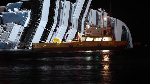 The cruise ship Costa Concordia leans on its side after running aground the tiny Tuscan island of Giglio, Italy, Jan. 18, 2012. The $450 million ship was carrying more than 4,200 passengers and crew when it slammed into a reef after the captain made an un 