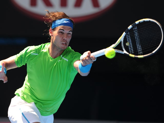 Rafael Nadal makes a forehand return to Tommy Haas 