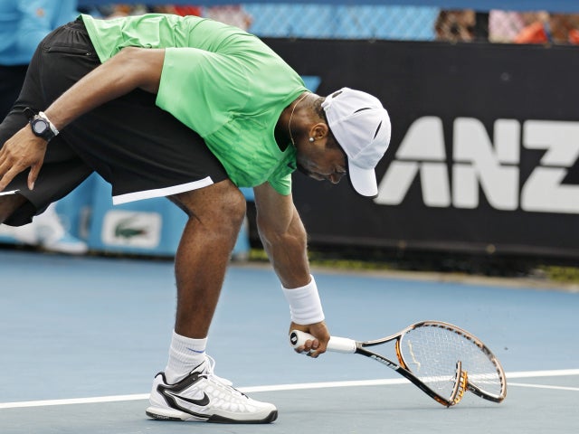 Donald Young smashes his racquet in frustration  