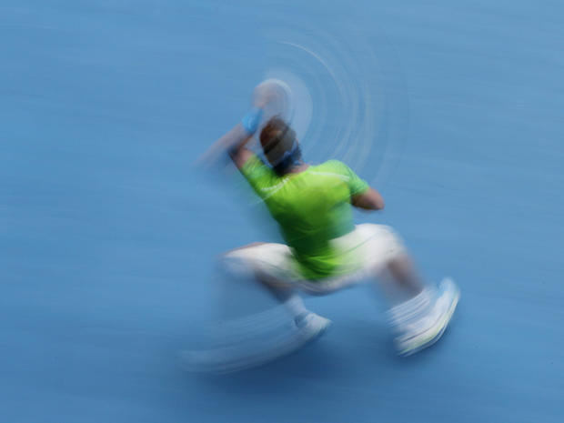 Rafael Nadal makes a forehand return  