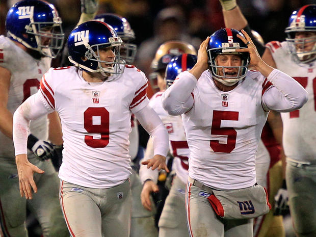 Lawrence Tynes and punter Steve Weatherford celebrate after Tynes kicked the game winning field goal 