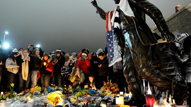 Students and other mourners gather around the statue of Joe Paterno, the former Penn State football coach who died earlier in the day, outside Beaver Stadium on the campus of Penn State Jan. 22, 2012, in State College, Pa. Paterno, who was 85, died due to 