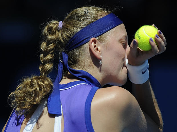 Petra Kvitova wipes the sweat from her face 