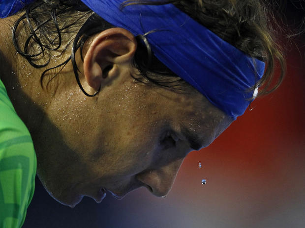 Beads of sweat drop off the forehead of Spain's Rafael Nadal  