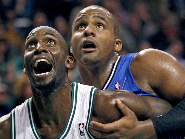 Kevin Garnett and Glen Davis look for the bounce on a rebound  
