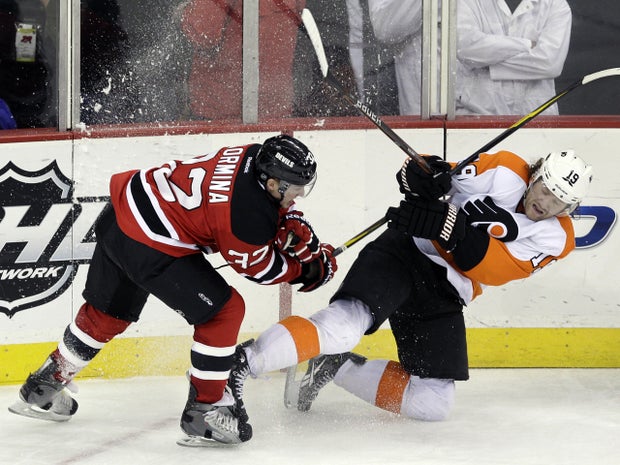 Scott Hartnell falls as he is hit by Matt Taormina 