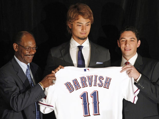 Yu Darvish poses with manager Ron Washington and general manager Jon Daniel  
