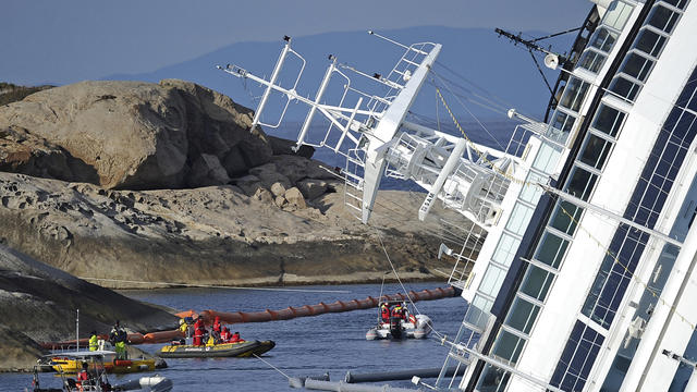 Rescuers and divers work near the stricken cruise liner Costa Concordia  