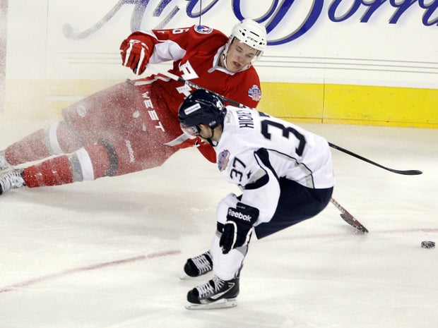 Kevin Connauton falls as he tries to control the puck 
