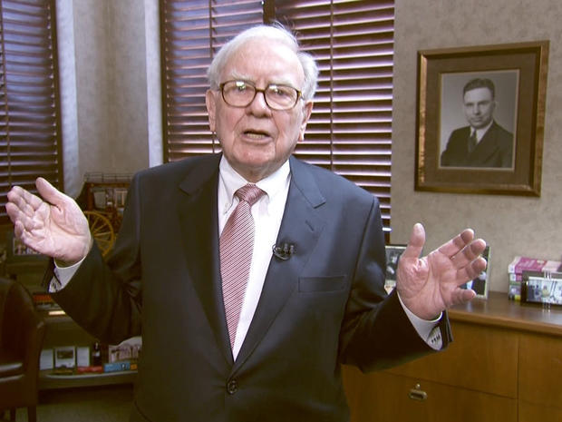 A photo of Warren Buffett's father hangs on his office wall; He uses his father's desk 