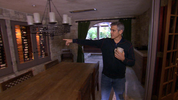 George Clooney shows off his wine collection during a tour of his L.A. home 